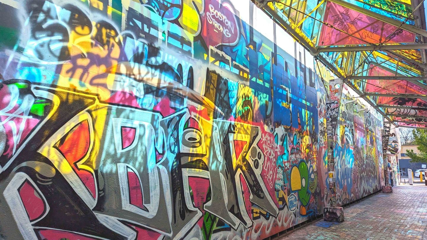 Bright and dramatic wall art fills Graffiti Alley in Central Square.