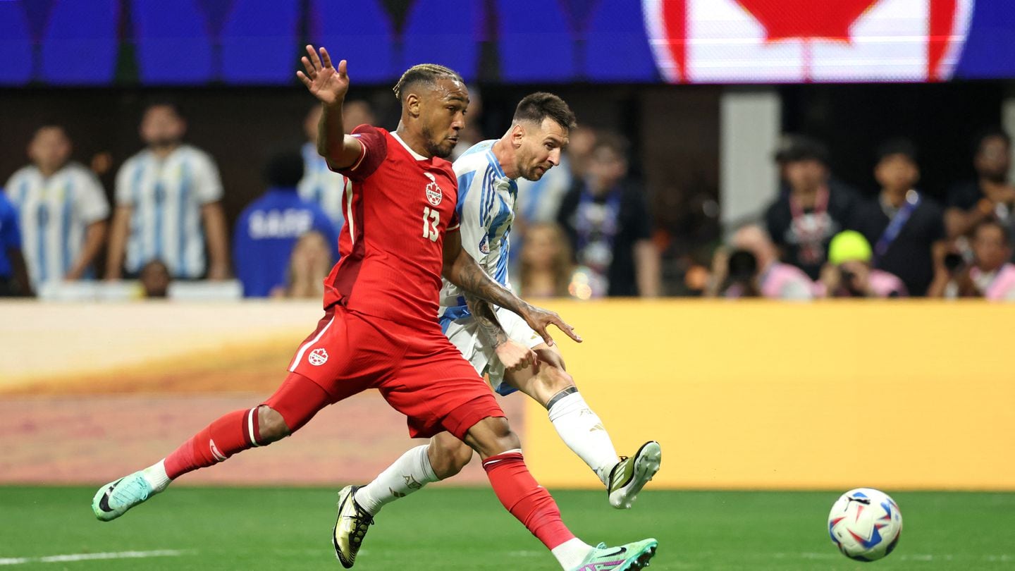 Lionel Messi beats Canadian defender Derek Cornelius.